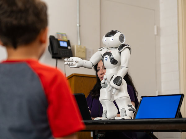 A child looks at the NAO - a humanoid robot for social interaction.