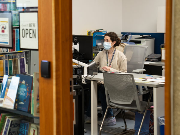 Staff member in library office