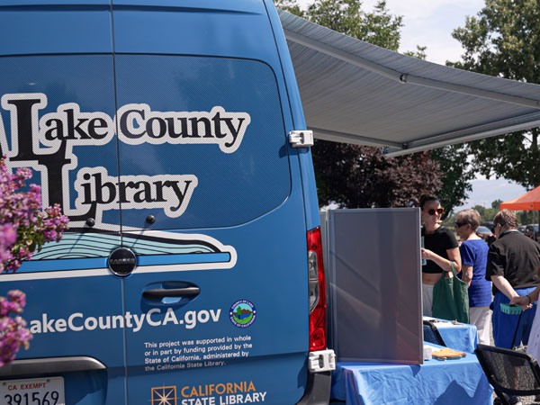 A man shelves books inside a bookmobile.