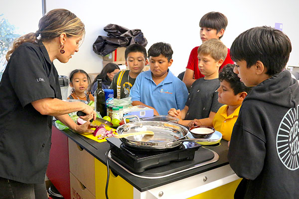 Children watching cooking demonstration.