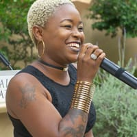 LaRae Nicole singing the Negro National Hymn in the Fragrence Garden at the California State Library.