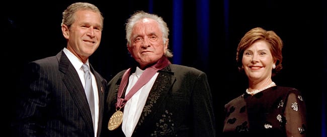 President George W. Bush and Mrs. Laura Bush with 2001 National Medal of Arts Recipient Johnny Cash. Records of the White House Photo Office (George W. Bush Administration), National Archives.