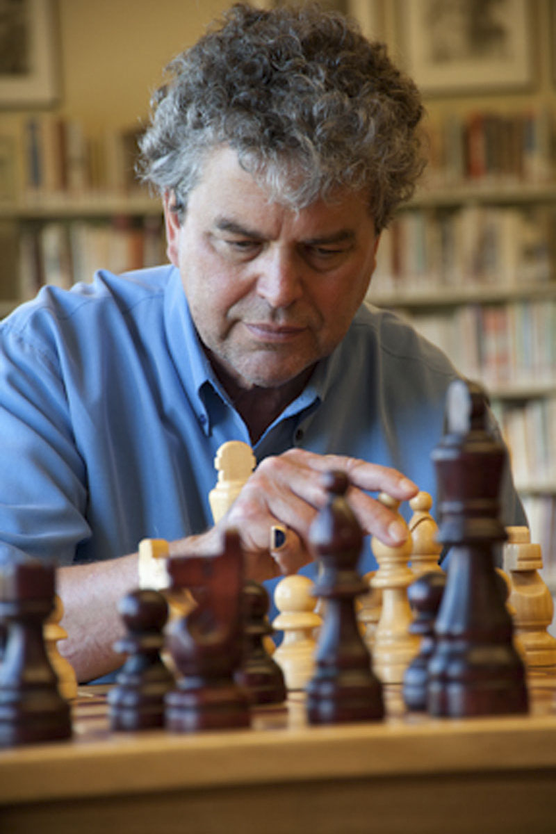 Man playing a game of chess in his public library. Photo credit the Get Involved Project.