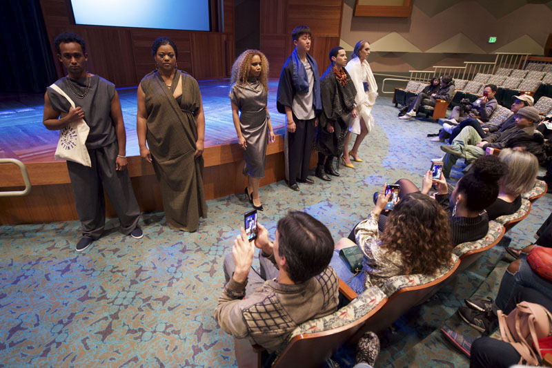 Group of adults in an auditorium watching people model a collection of clothing designs. Photo Courtesy of the Los Angeles Public Library.