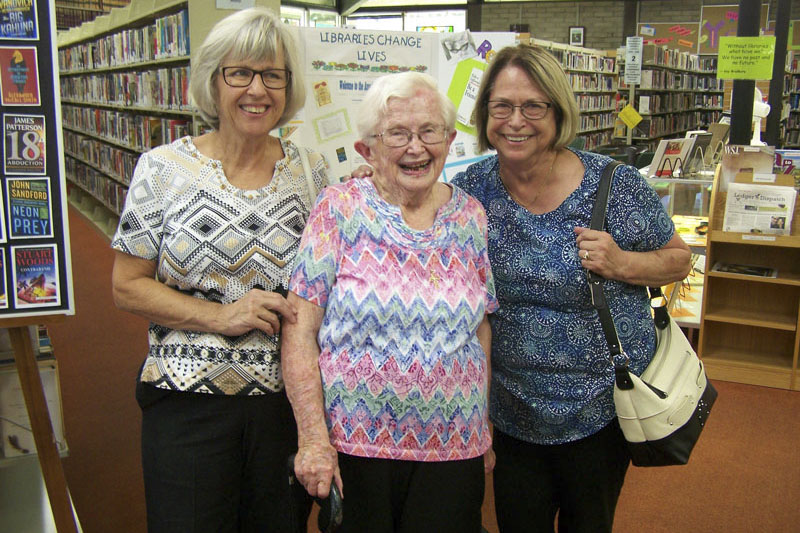 Three female older adults in a group, smiling, in their library. Photo courtesy Amador County library.