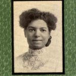 Black-and-white portrait of a Black woman with a lacy-collared dress.