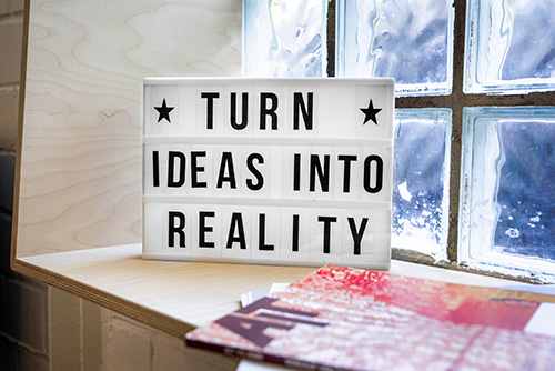 Window with a sign that says Turn Ideas Into Reality.